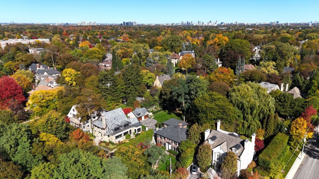 Large stone and brick Lawrence Park homes among fall trees, seen from above
